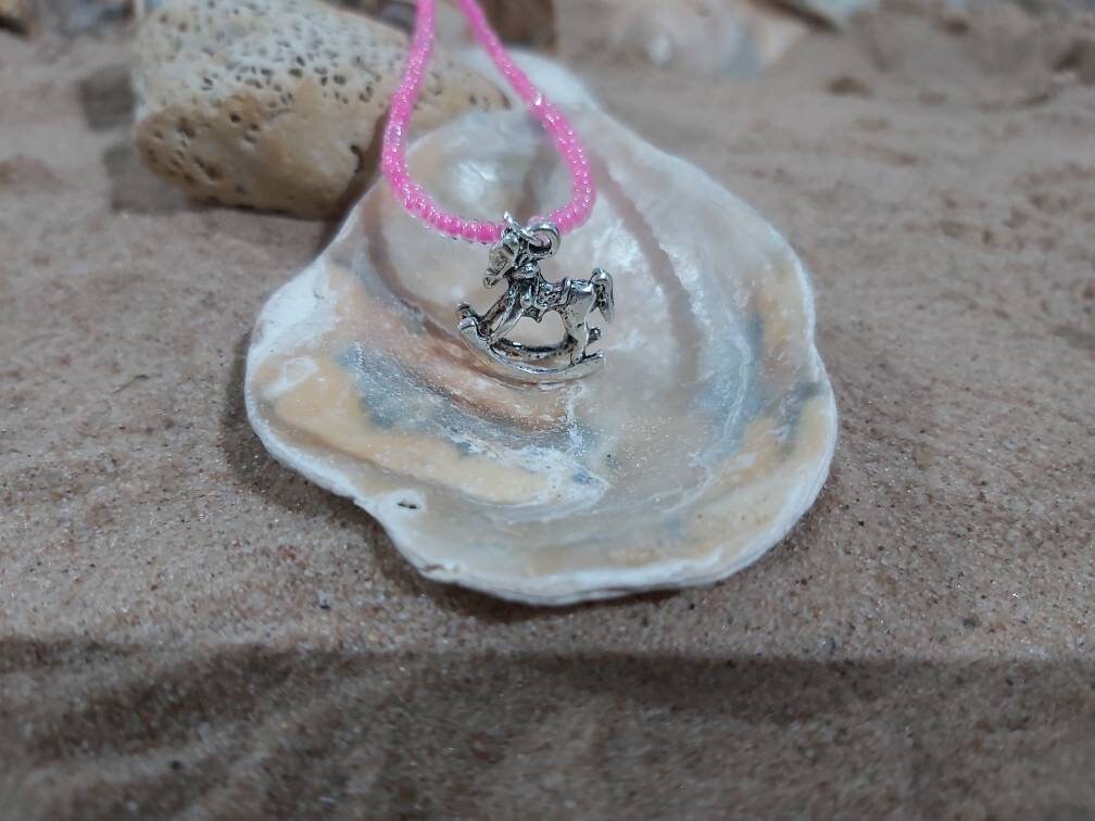 Rocking horse charm on a dainty seed bead anklet