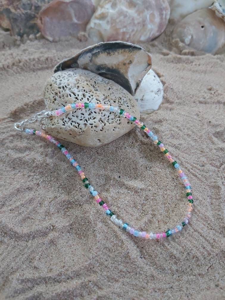 Star charm on a dainty seed bead anklet.