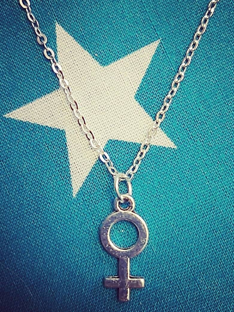 Female symbol necklace and earrings.
